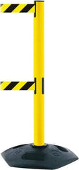 Tensator - 38" High, 2-1/2" Pole Diam, 4 Way Stanchion - 19" Base Diam, Octagon Recycled Rubber Base, Yellow Plastic Post, 7-1/2' x 2" Tape, Dual Line Tape, For Outdoor Use - Caliber Tooling